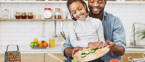 Cute little afro girl and his father making salad together. Happy childhood concept, copy space; Shutterstock ID 1397569916; purchase_order: -; job: -; client: -; other: - Cute little afro girl and his father making salad together. Happy childhood concept, copy space; Shutterstock ID 1397569916; purchase_order: -; job: -; client: -; other: -