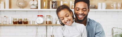 Cute little afro girl and his father making salad together. Happy childhood concept, copy space; Shutterstock ID 1397569916; purchase_order: -; job: -; client: -; other: -